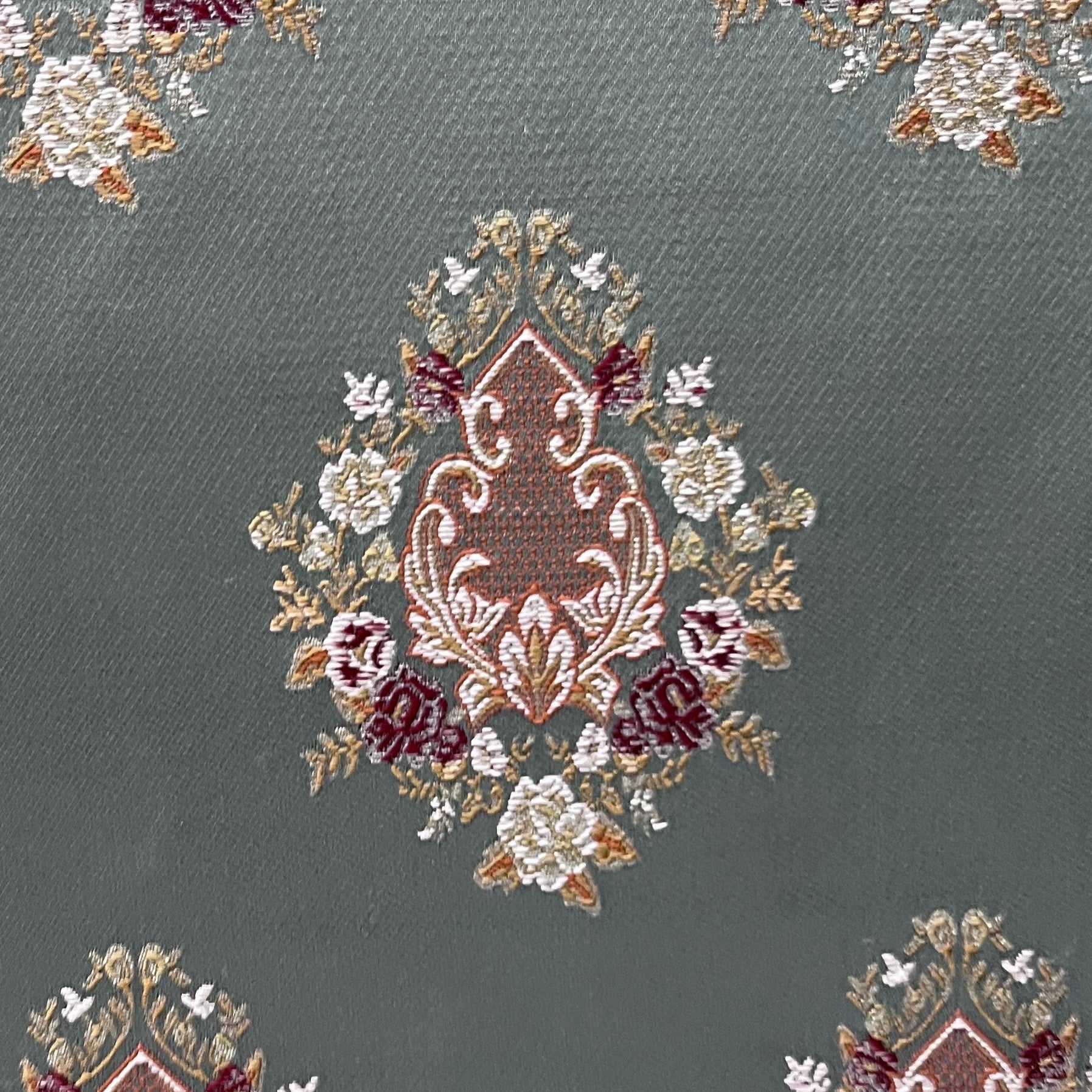 Decorative pattern with floral damask motif medallion elements on a Teal Blue background