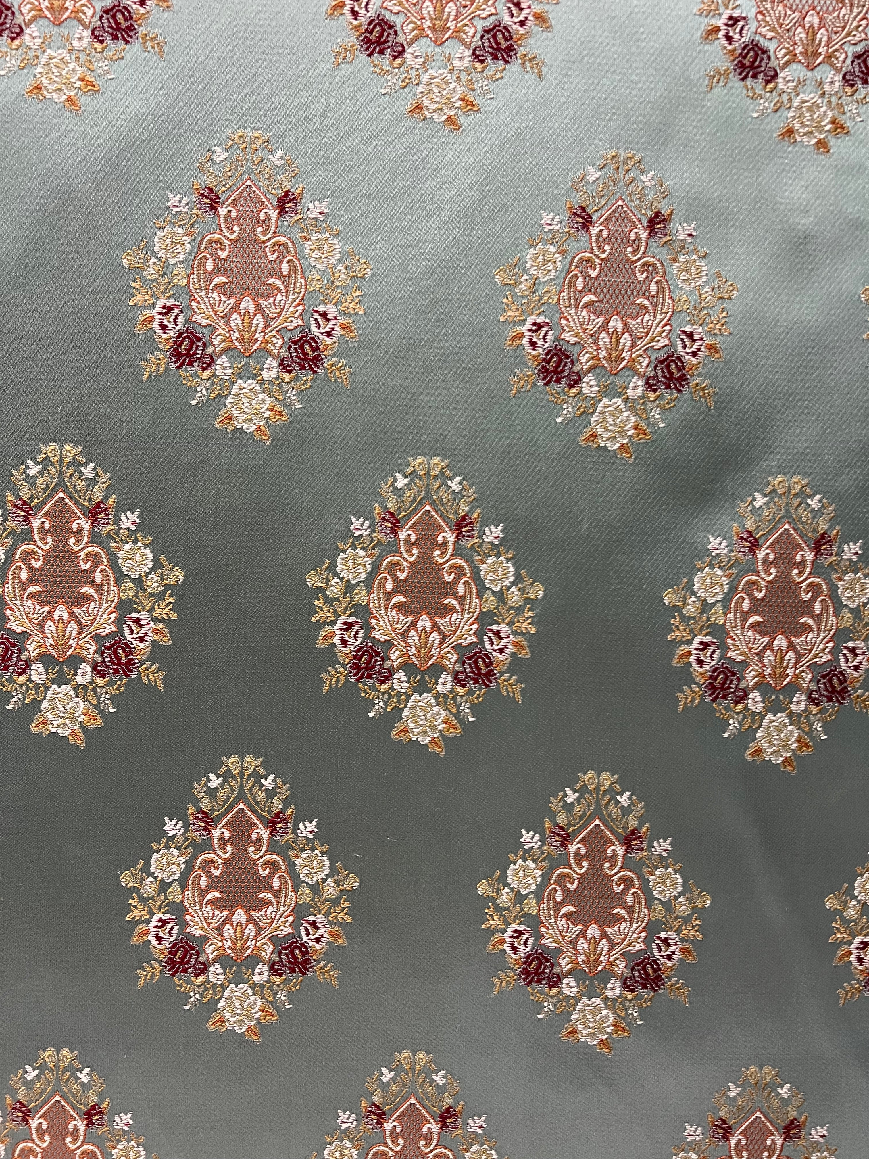 Decorative pattern with floral damask motif medallion elements on a Teal Blue background