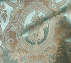 Close-up of damask ornate floral pattern on fabric with Pista color background