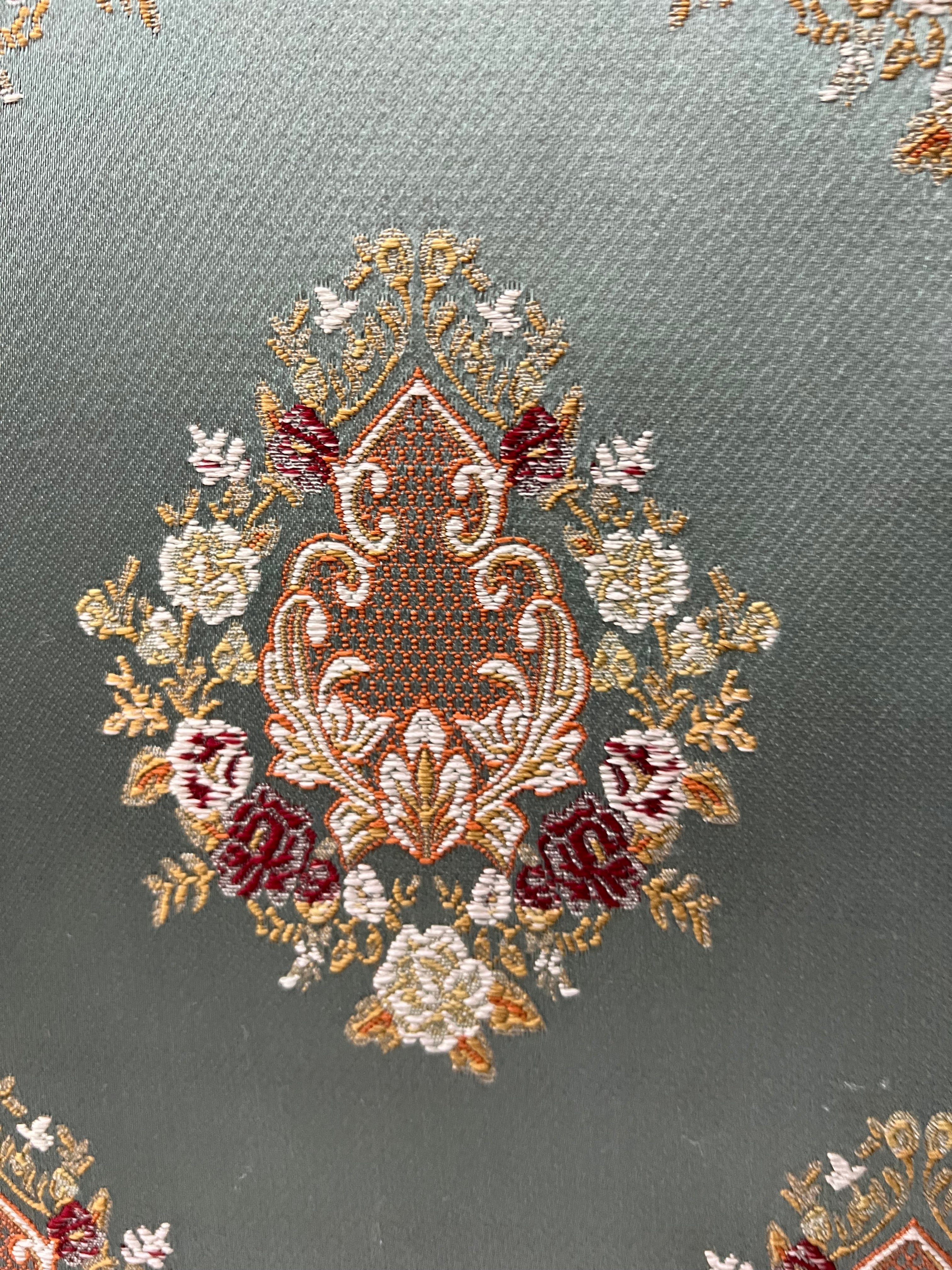 Decorative pattern with floral damask motif medallion elements on a Teal Blue background