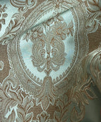 Close-up of damask ornate floral pattern on fabric with Pista color background