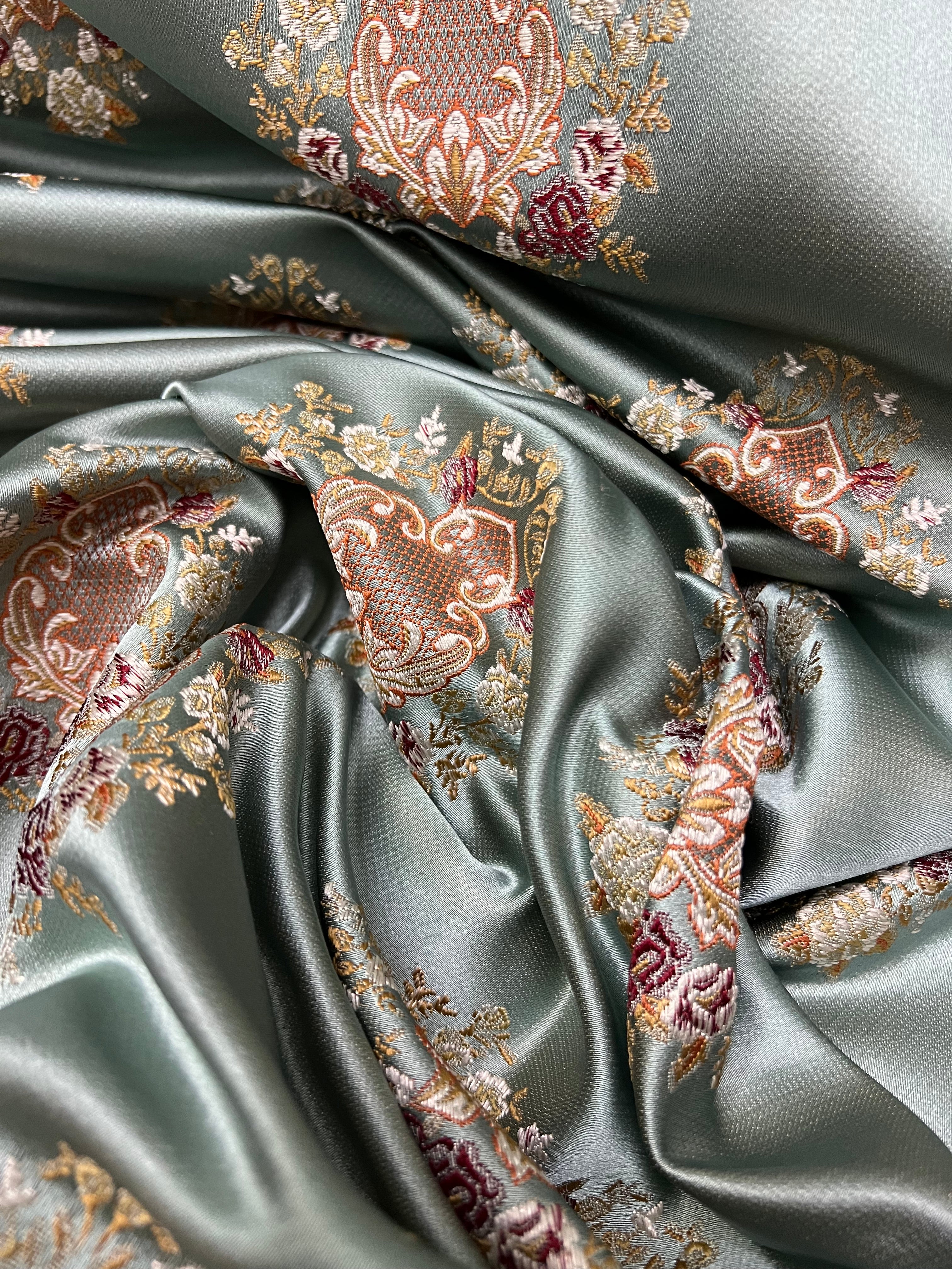 Decorative pattern with floral damask motif medallion elements on a Teal Blue background