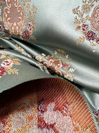 Decorative pattern with floral damask motif medallion elements on a Teal Blue background