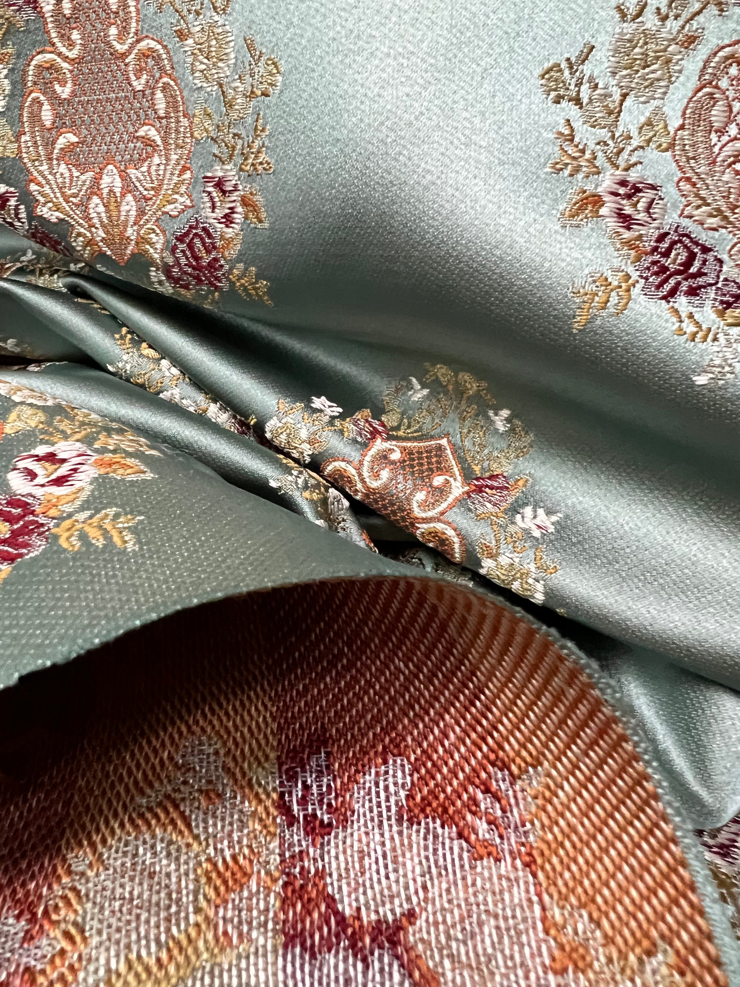 Decorative pattern with floral damask motif medallion elements on a Teal Blue background
