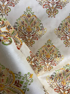 Decorative fabric pattern with Orange designs on a taupe background