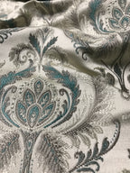 Sapphire blue damask fabric folded, texture and sheen close-up