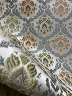 Decorative fabric with intricate Rust floral pattern on a beige background