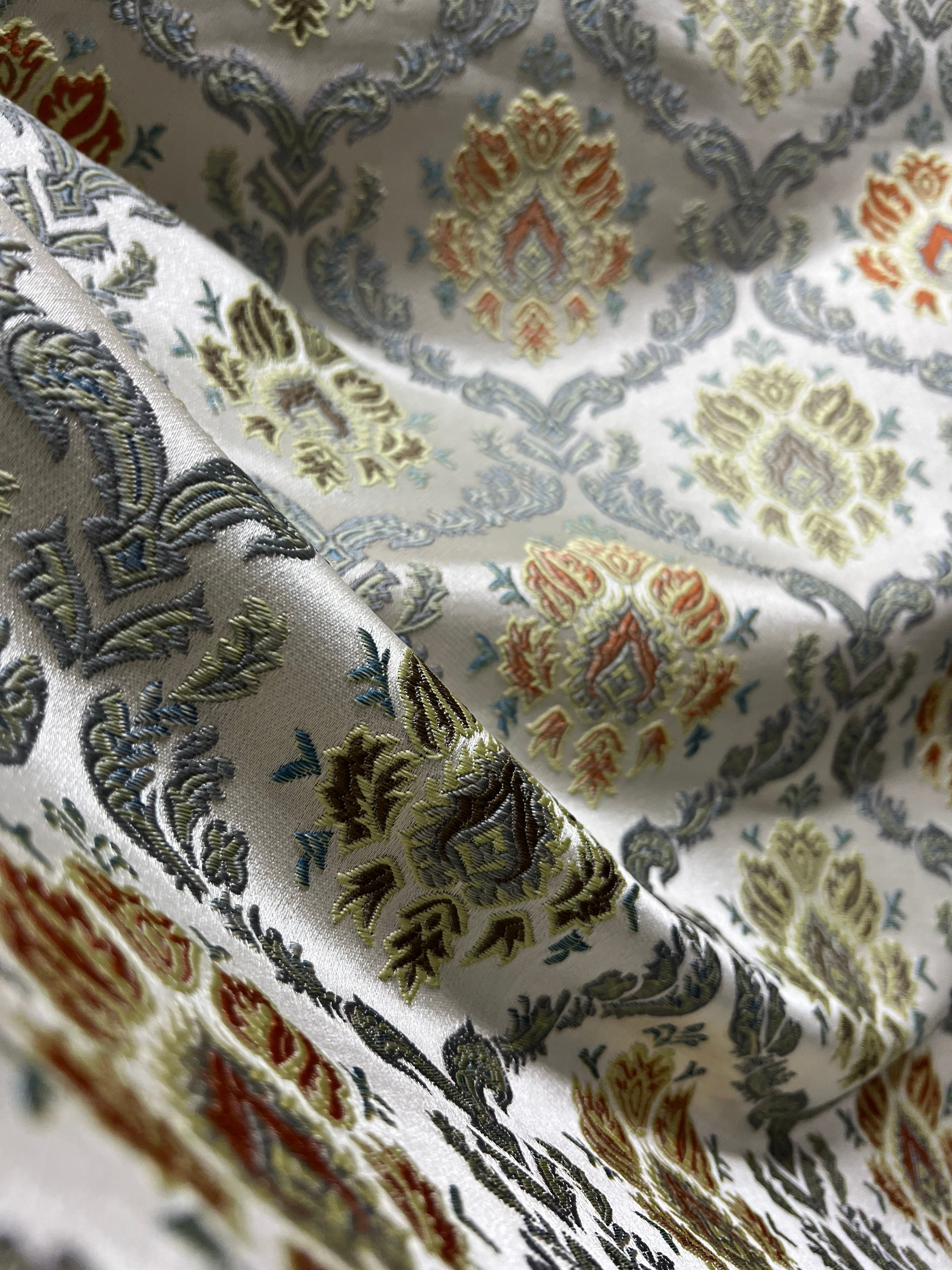 Decorative fabric with intricate Rust floral pattern on a beige background