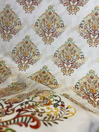 Decorative fabric pattern with Orange designs on a taupe background