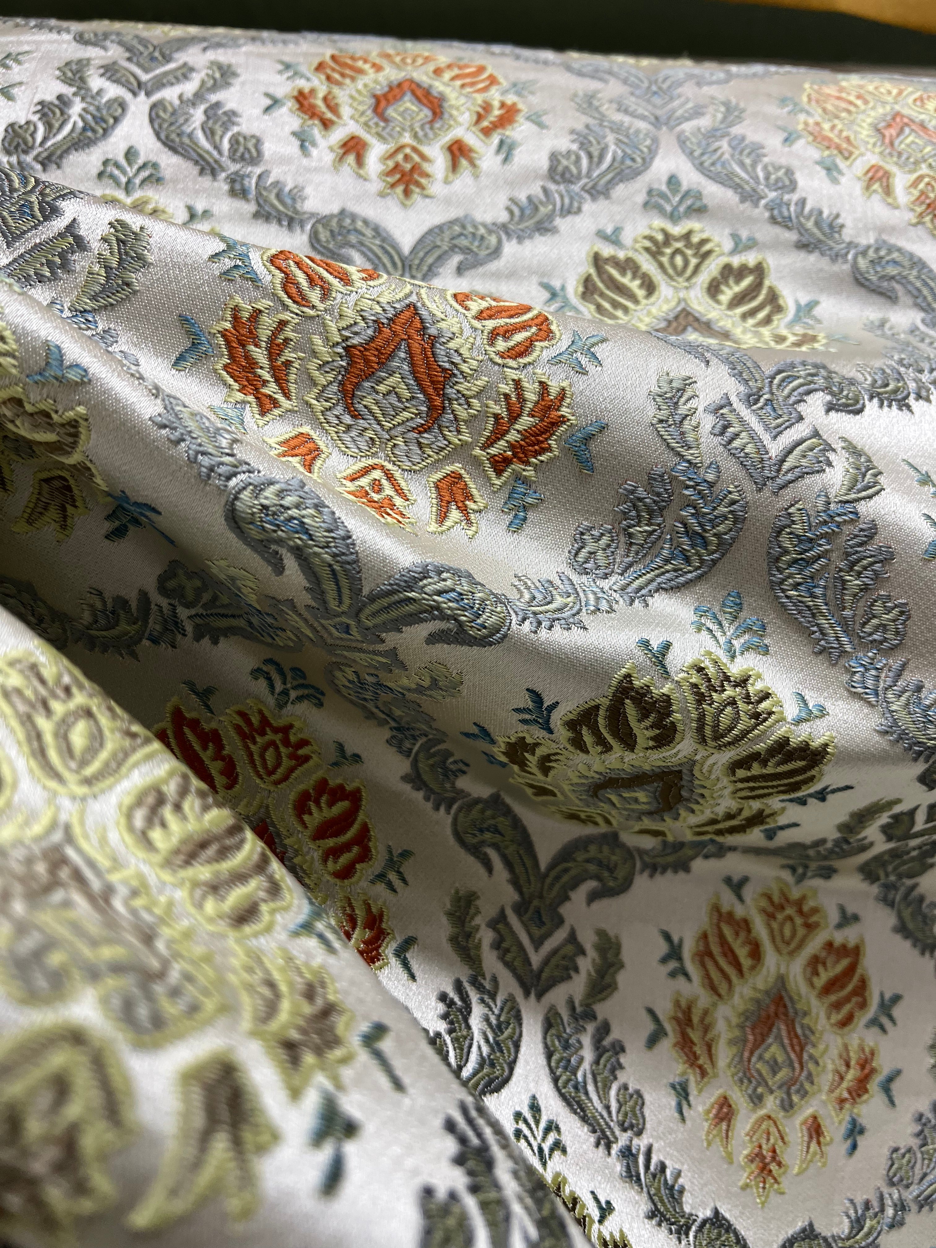 Decorative fabric with intricate Rust floral pattern on a beige background