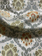 Decorative fabric with intricate Rust floral pattern on a beige background