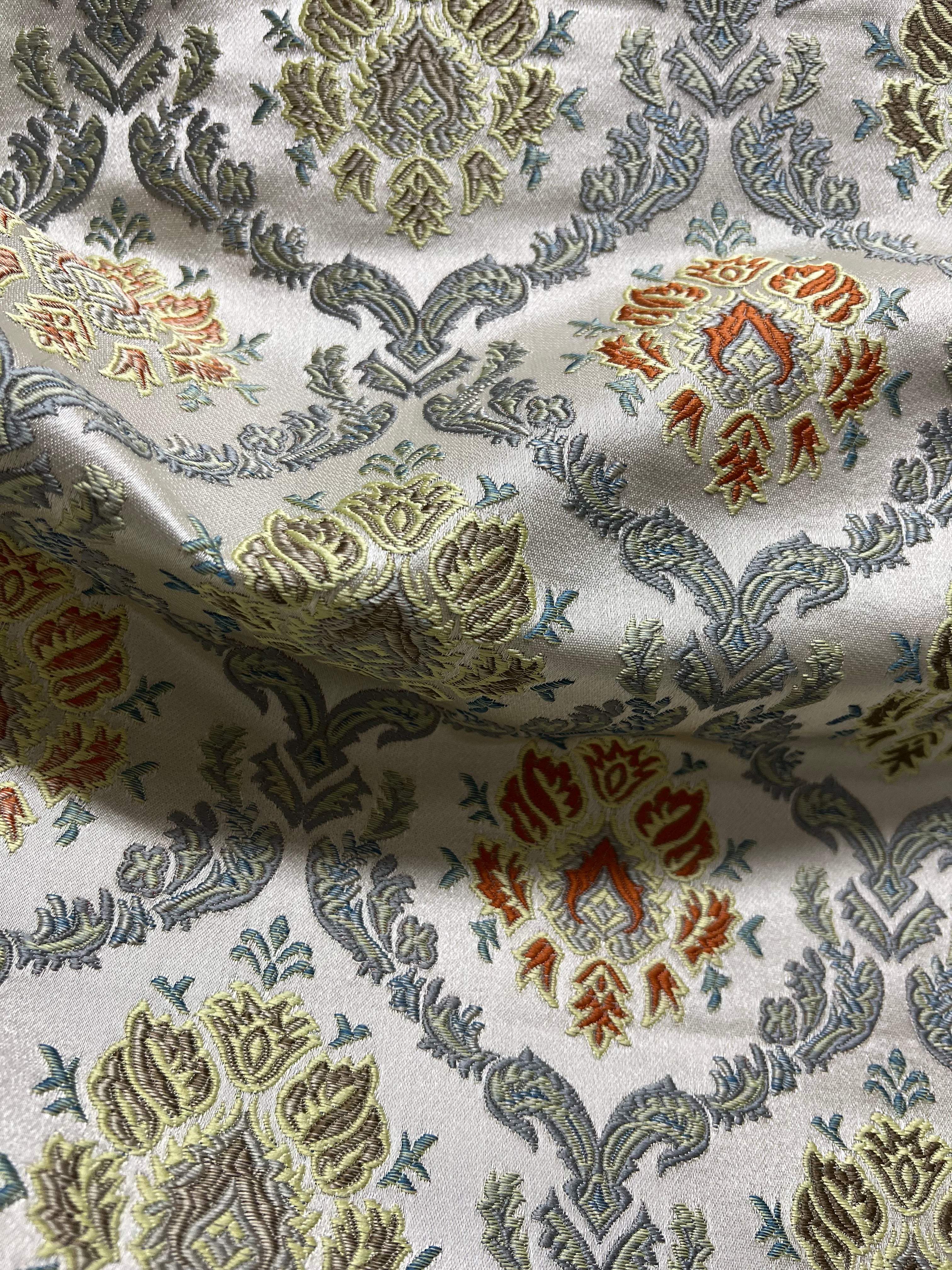 Decorative fabric with intricate Rust floral pattern on a beige background