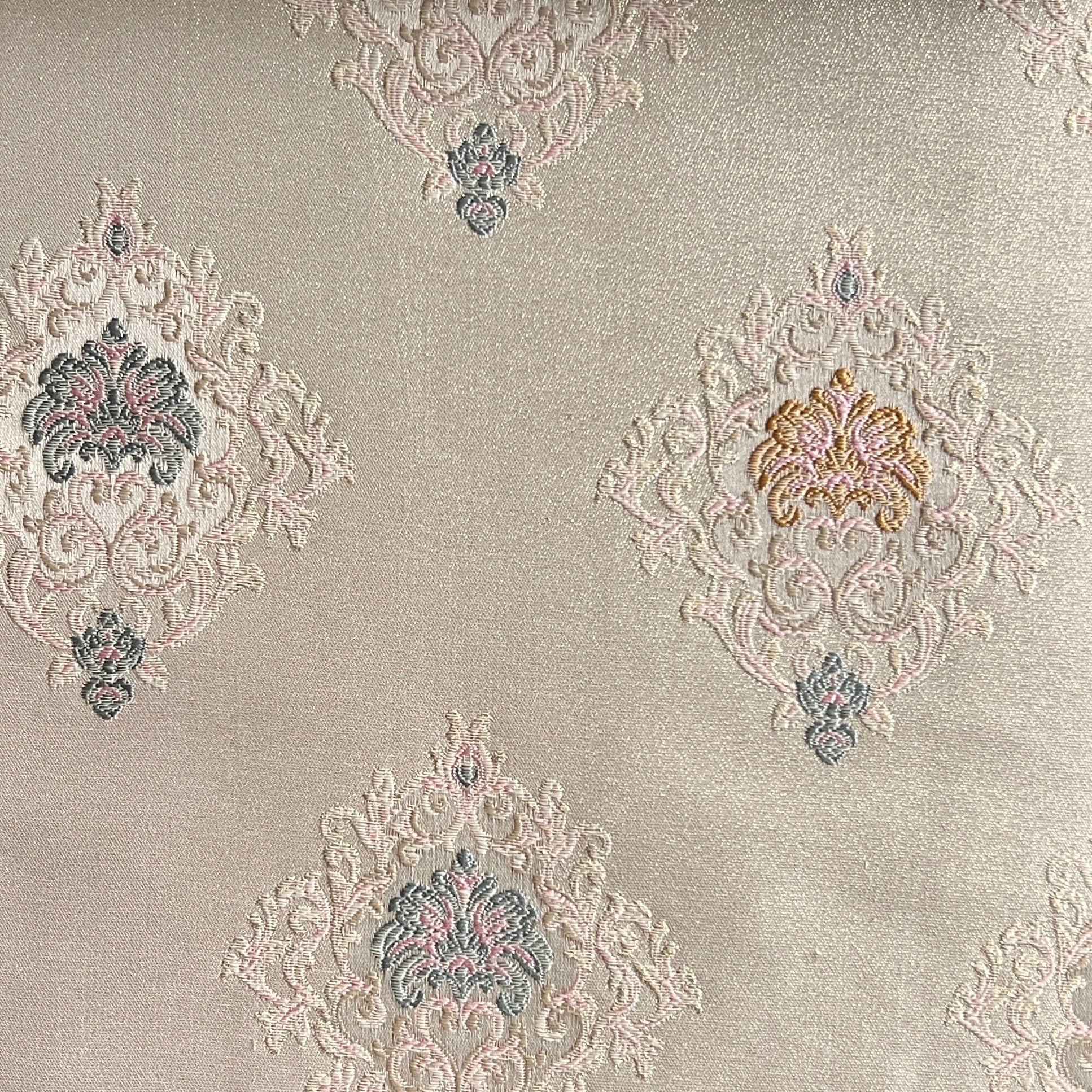Decorative fabric with intricate patterns on a Pinkish background