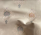 Decorative fabric with intricate patterns on a Pinkish background