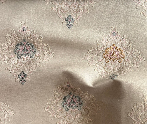 Decorative fabric with intricate patterns on a Pinkish background