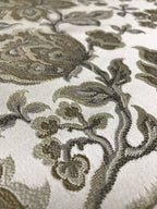 Gold floral jacquard fabric folded, texture close-up.