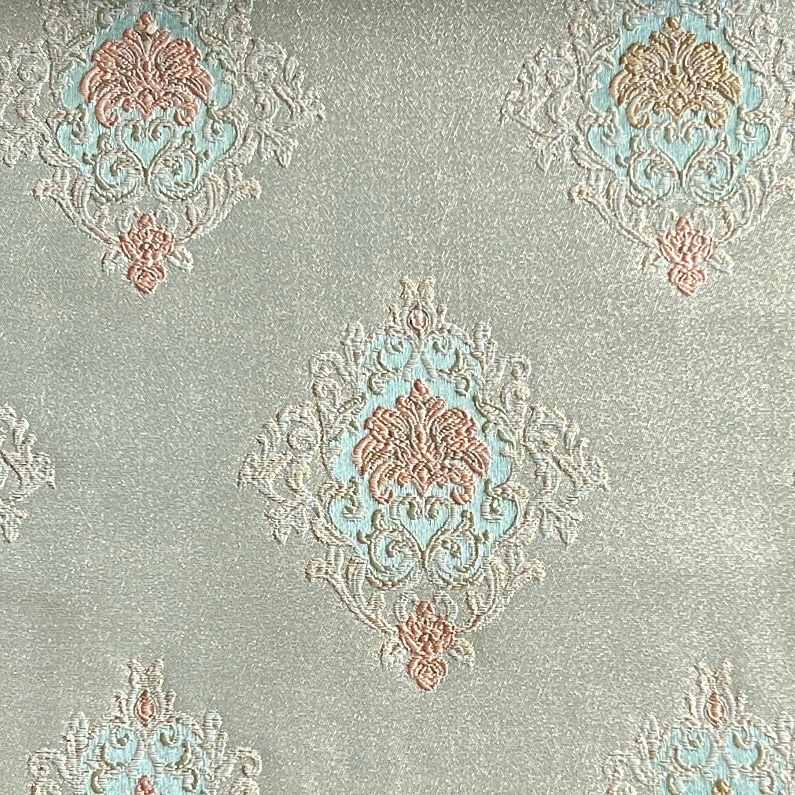 Decorative fabric with intricate patterns on a Pista background