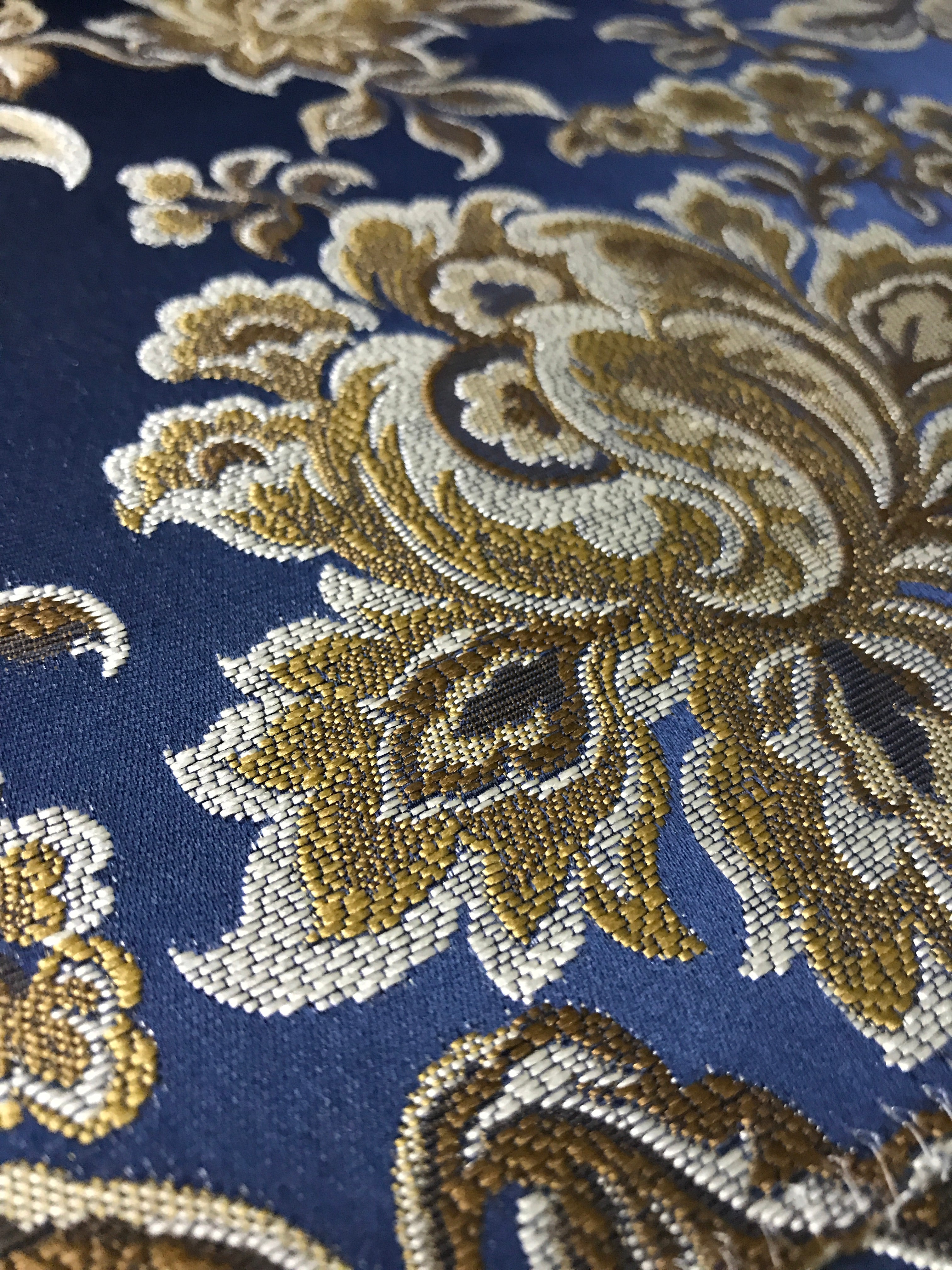 Navy floral jacquard fabric swatch showing repeat pattern detail.