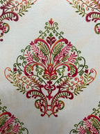 Decorative fabric pattern with Maroon designs on a taupe background