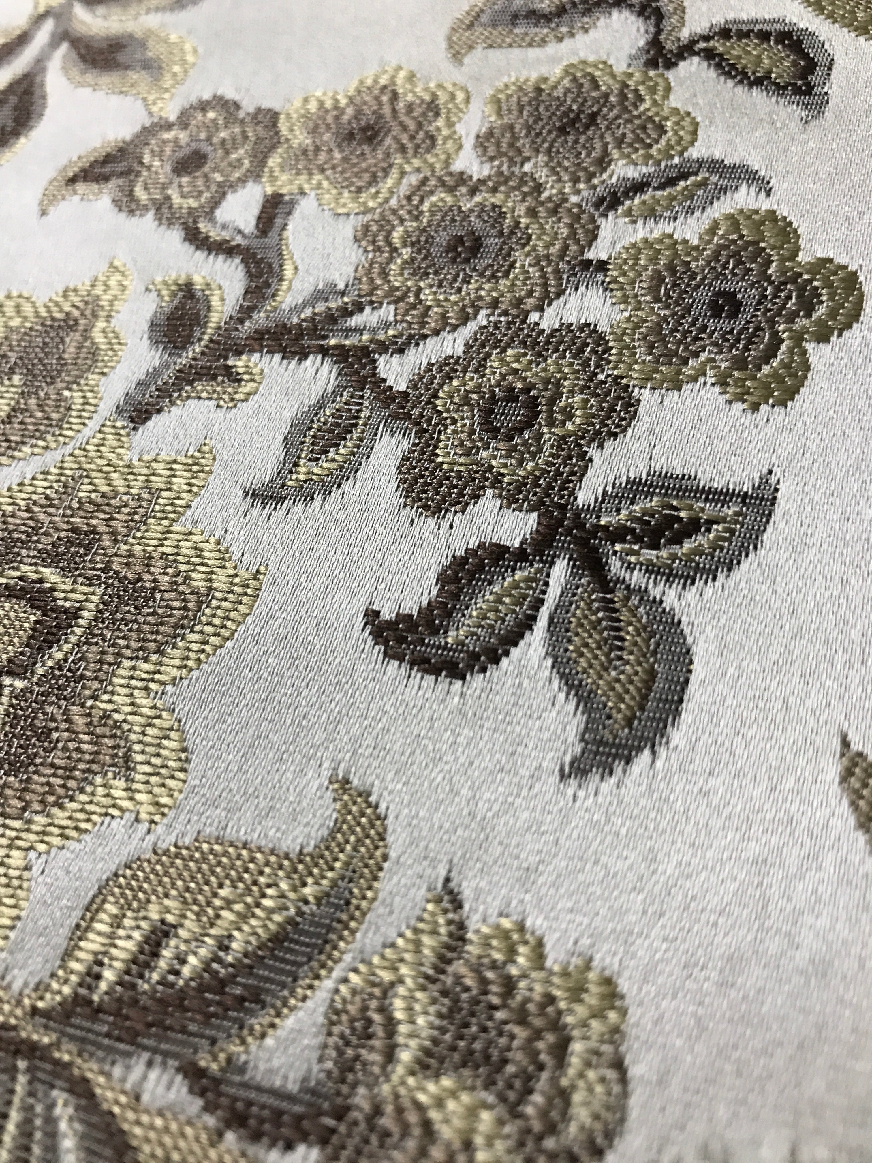 Taupe floral jacquard fabric swatch showing repeat pattern detail.