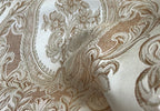 Close-up of damask ornate floral pattern on fabric with Cream color background