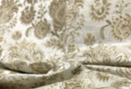 Patterned fabric with floral design in beige on a light Cream background