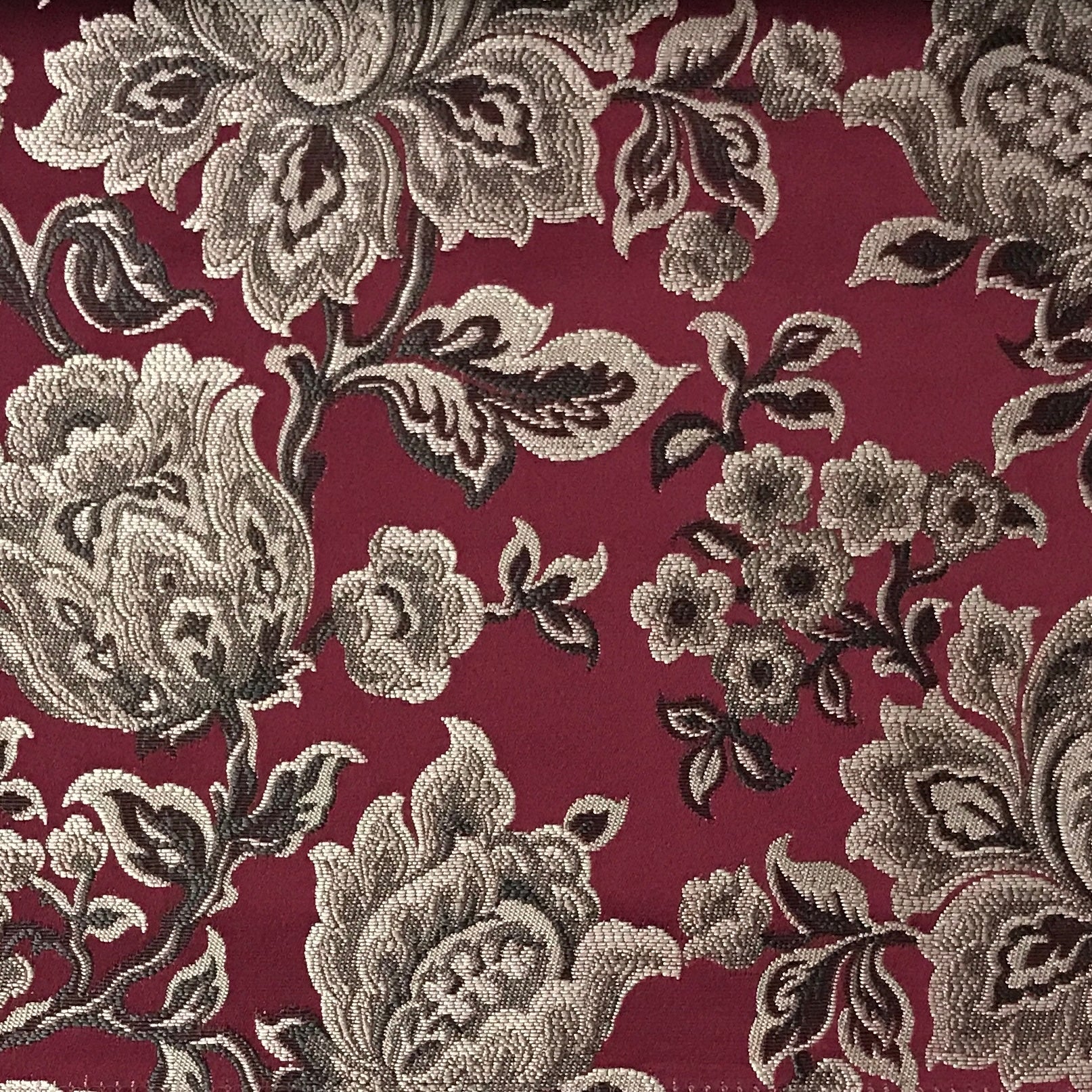 Maroon floral jacquard upholstery fabric by the yard, close-up pattern view.