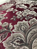 Maroon floral jacquard fabric swatch showing repeat pattern detail.