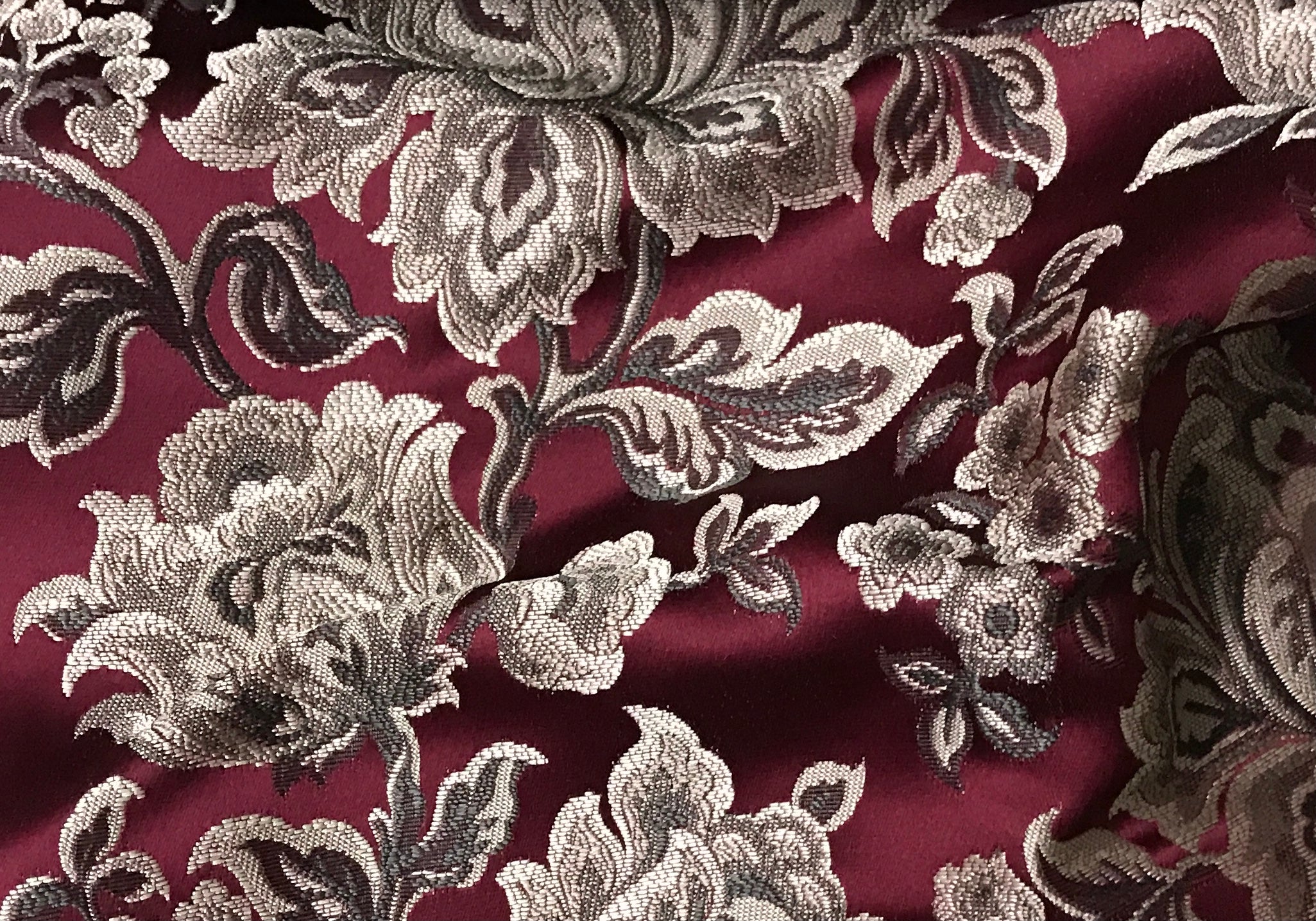 Maroon floral jacquard fabric by the yard, full pattern layout view.