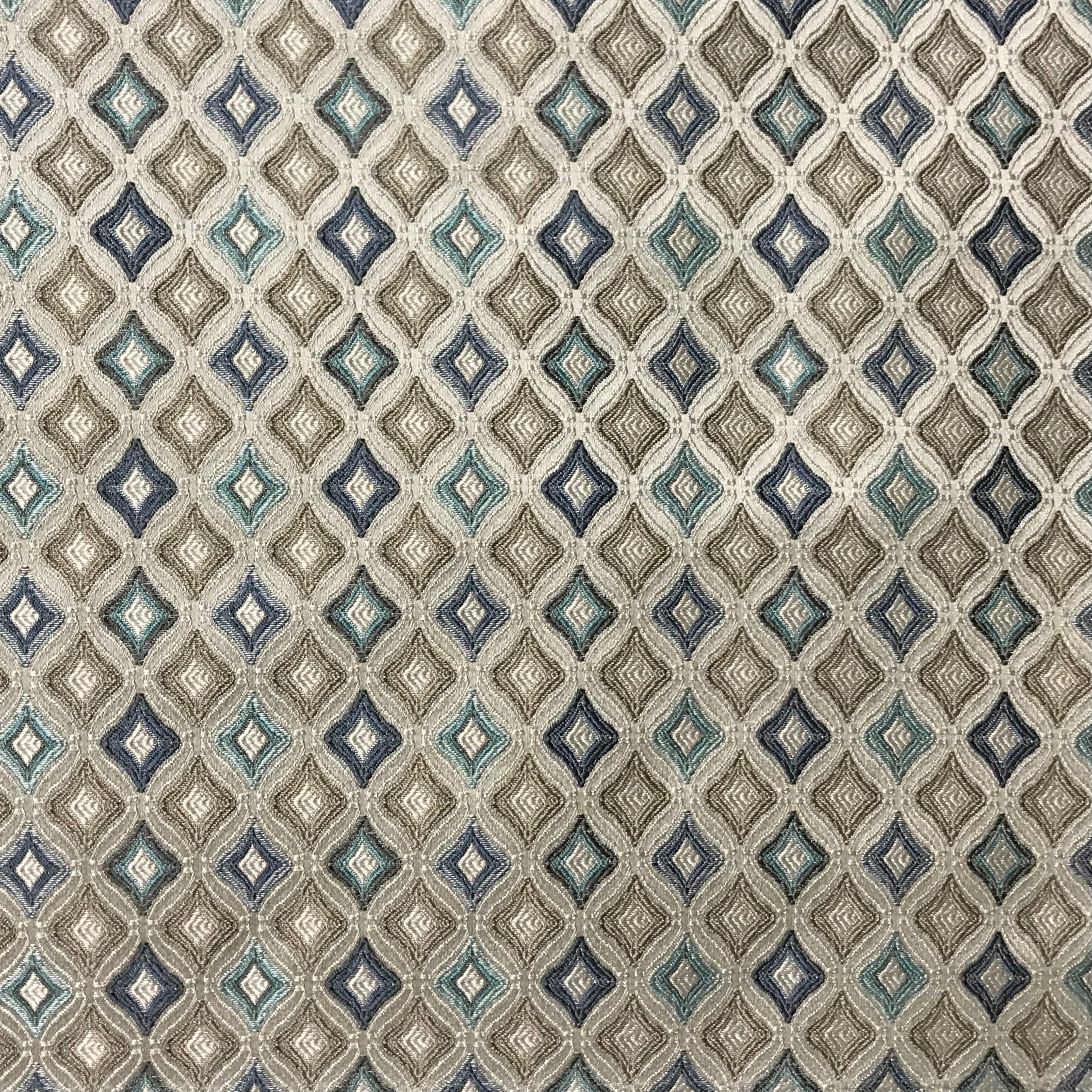 Patterned fabric with geometric design in blue, beige, and brown tones. Teal Sage