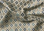 Patterned fabric with geometric design in shades of blue, beige, and gray. Teal Sage
