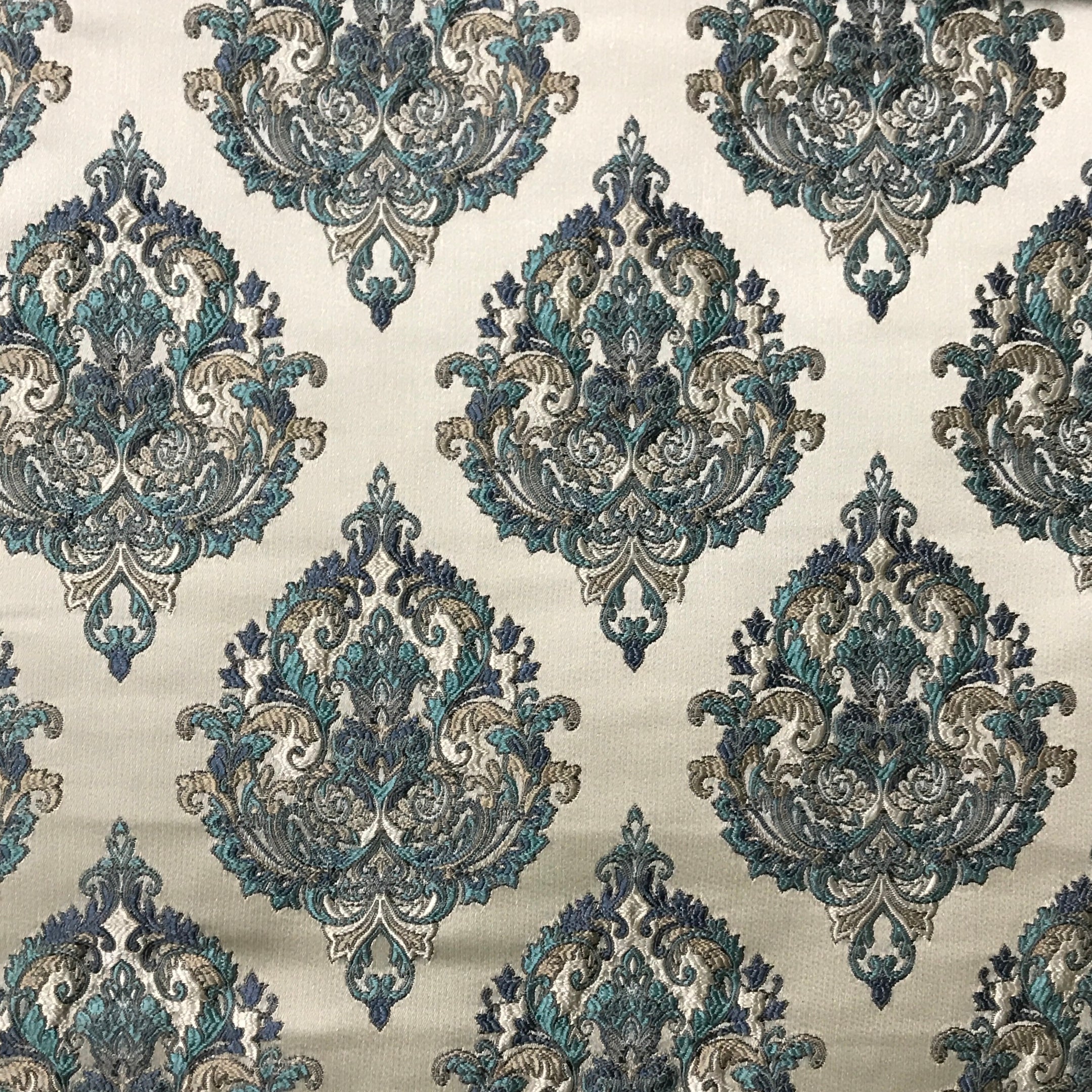 Decorative fabric with intricate blue and beige pattern on a beige background Teal Sage