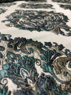 Close-up of intricate paisley pattern fabric with teal and brown colors. Teal Sage