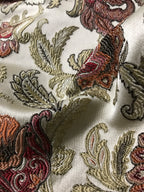 Close-up of embroidered fabric with floral patterns on a white background Sage Rose