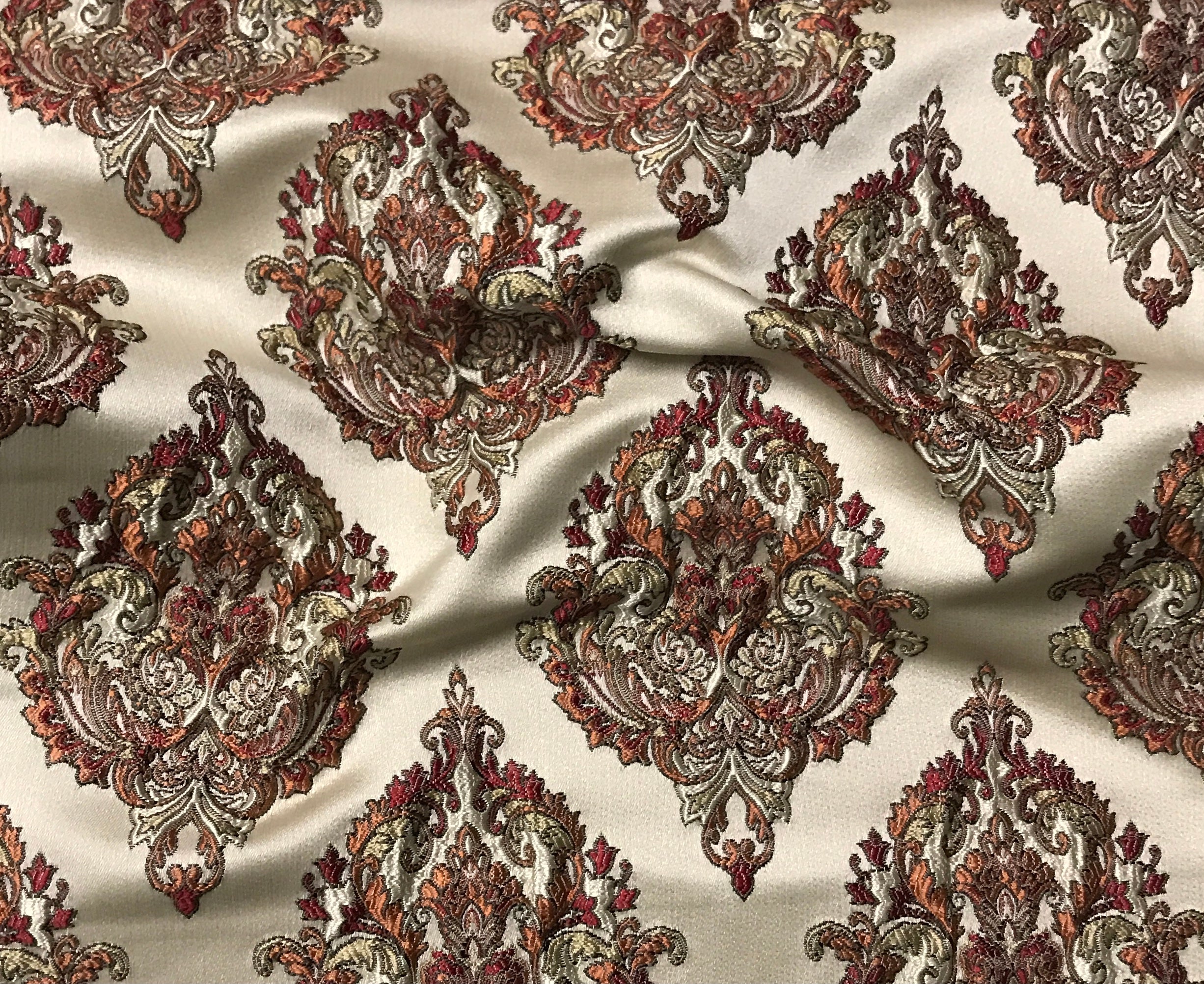 Decorative fabric with intricate paisley pattern on a beige background Sage Rose