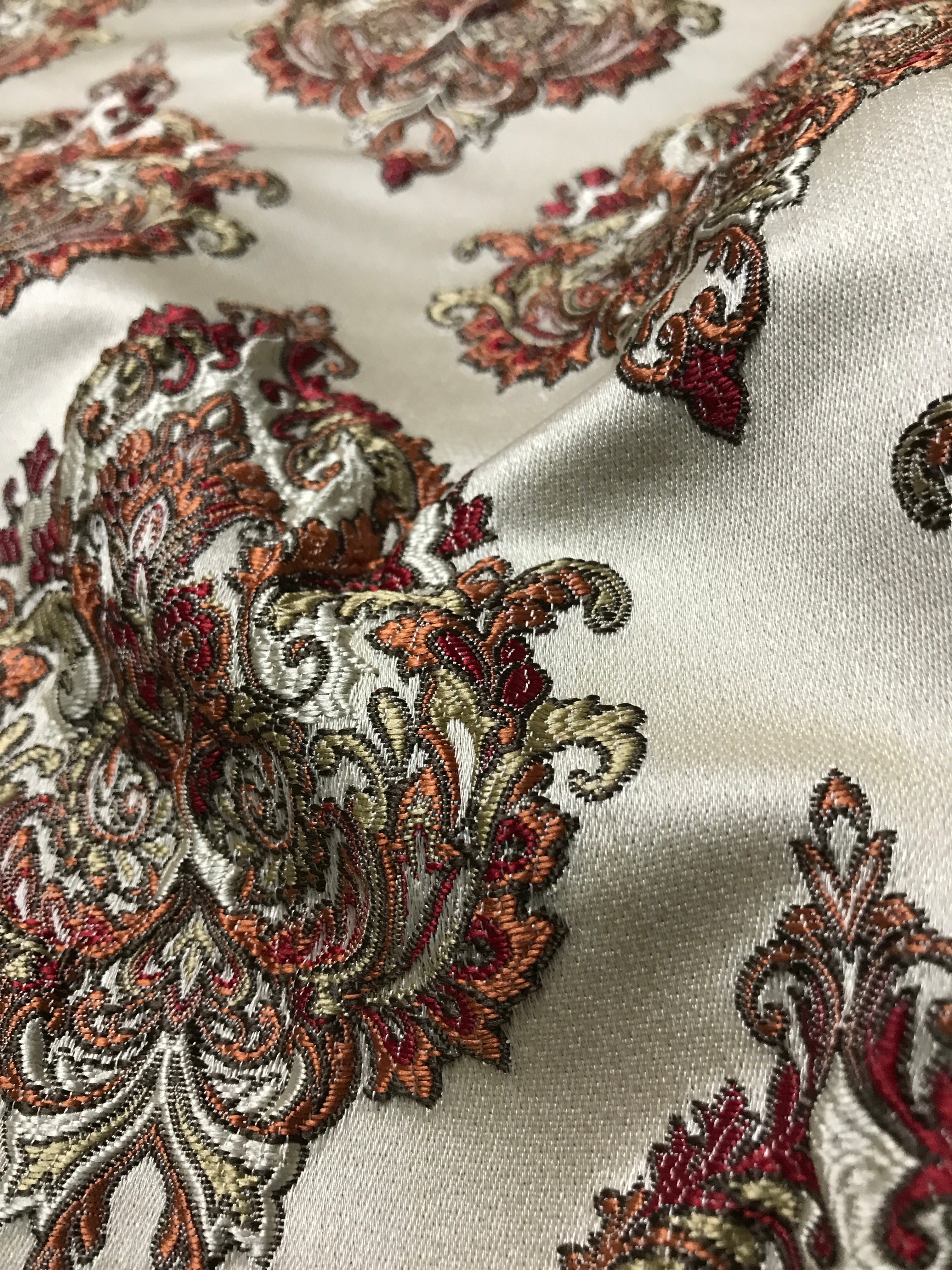 Close-up of intricate paisley pattern on fabric Sage Rose