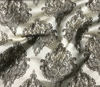Decorative black paisley pattern on a white fabric background Stone Age