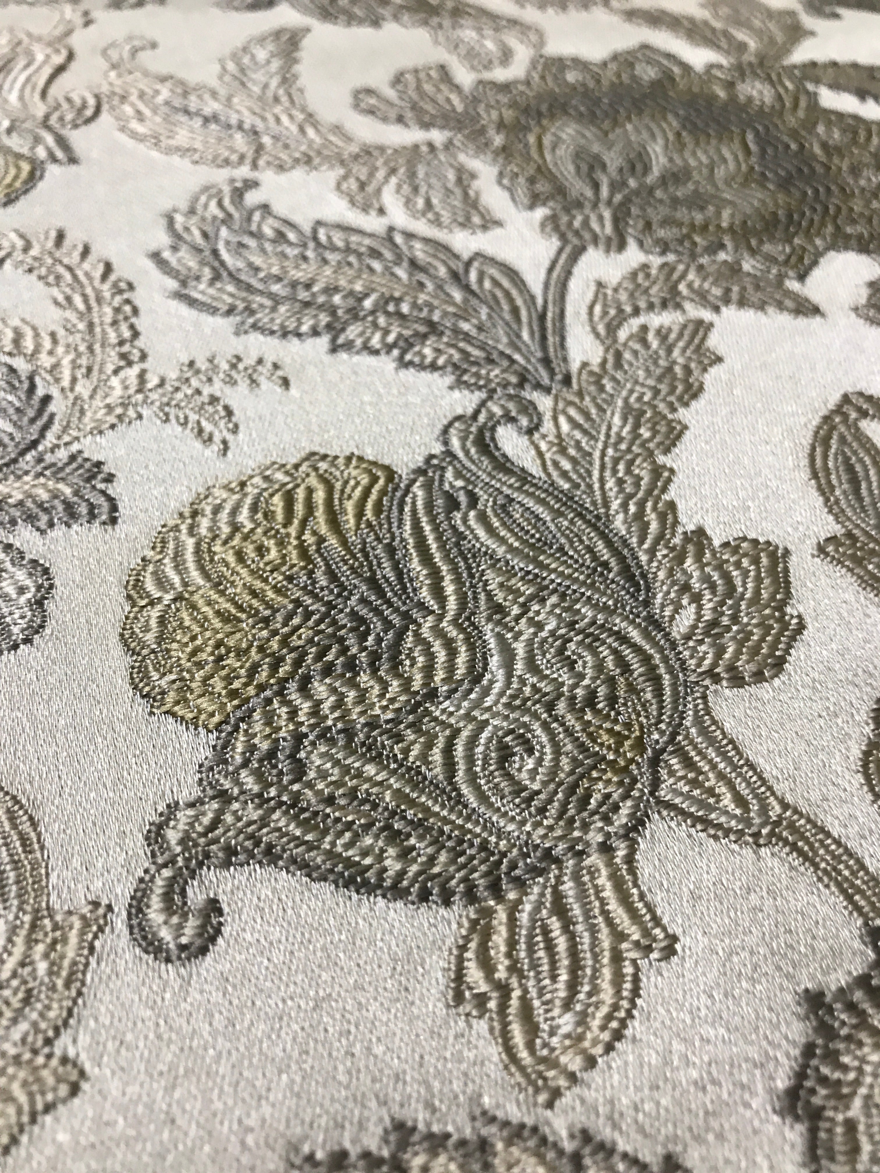Close-up of decorative fabric with floral patterns on a neutral background Olive Sage