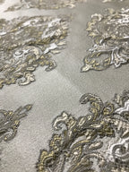 Close-up of decorative fabric with intricate patterns on a gray background Olive Sage