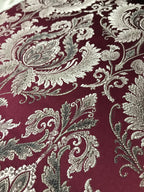Maroon damask fabric swatch showing repeat pattern detail