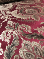 Maroon damask jacquard fabric close-up detail for dining chair reupholstery sold by the yard