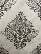 Decorative fabric pattern with Brown designs on a taupe background