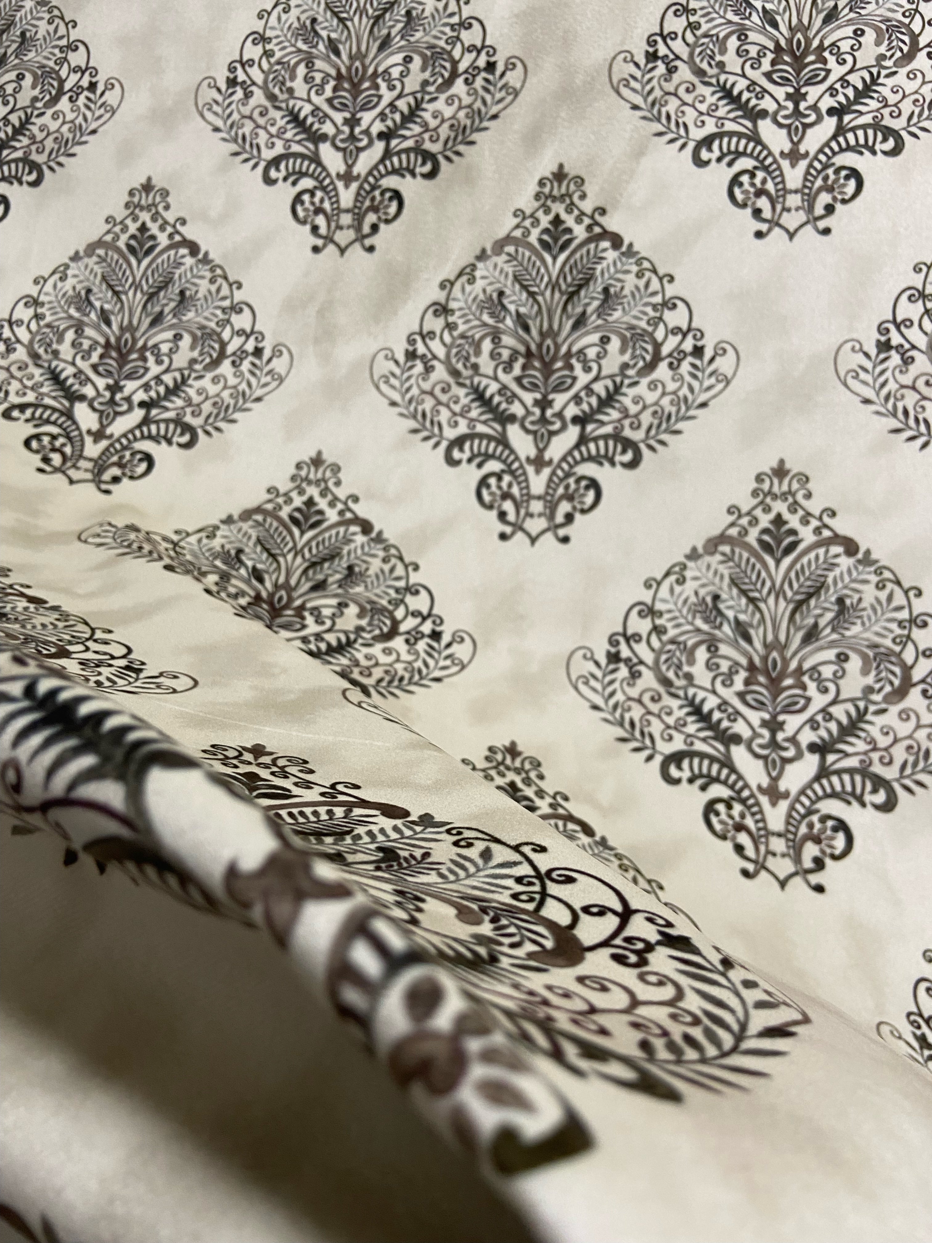 Decorative fabric pattern with Brown designs on a taupe background
