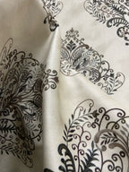 Decorative fabric pattern with Brown designs on a taupe background