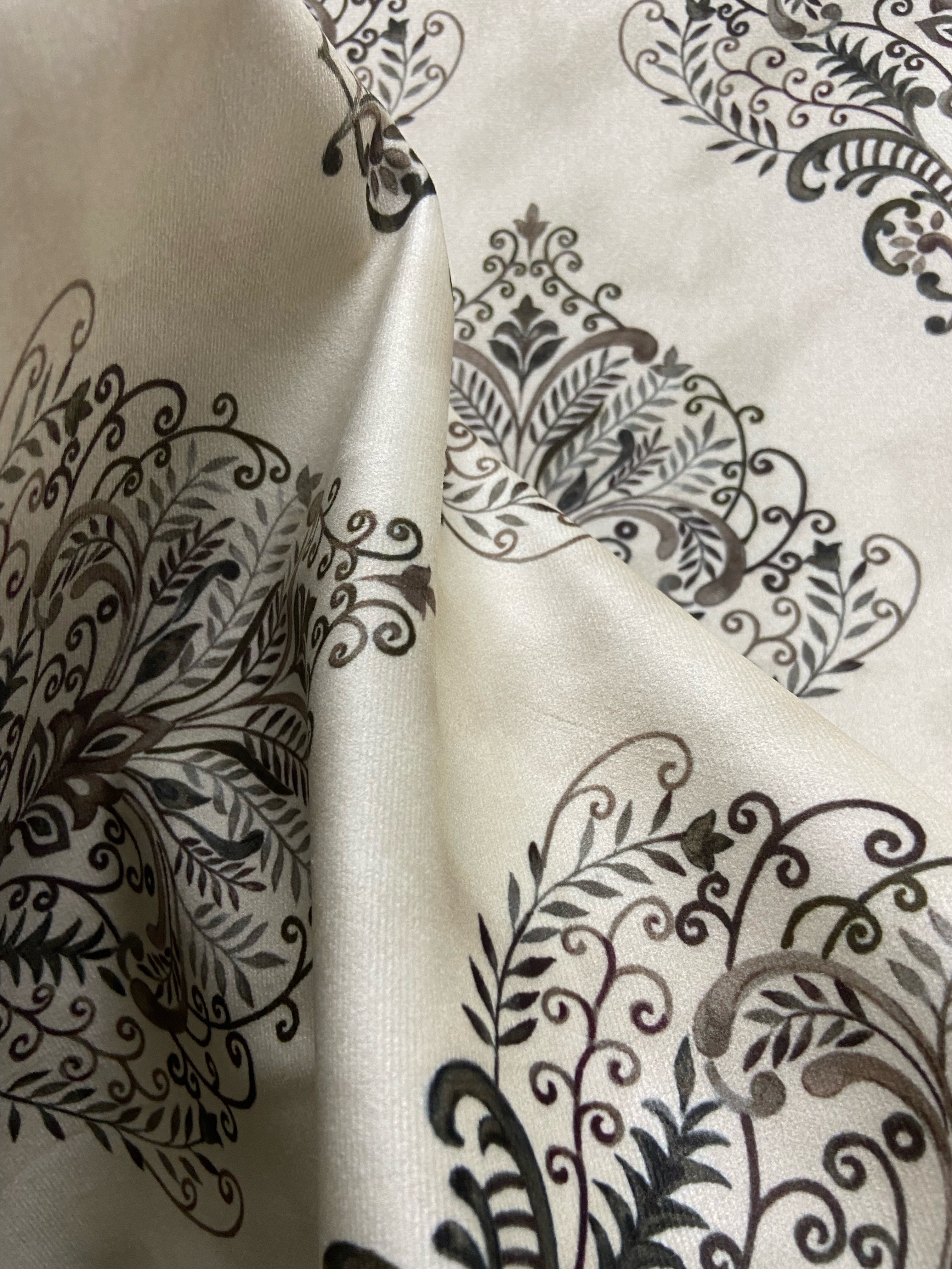Decorative fabric pattern with Brown designs on a taupe background