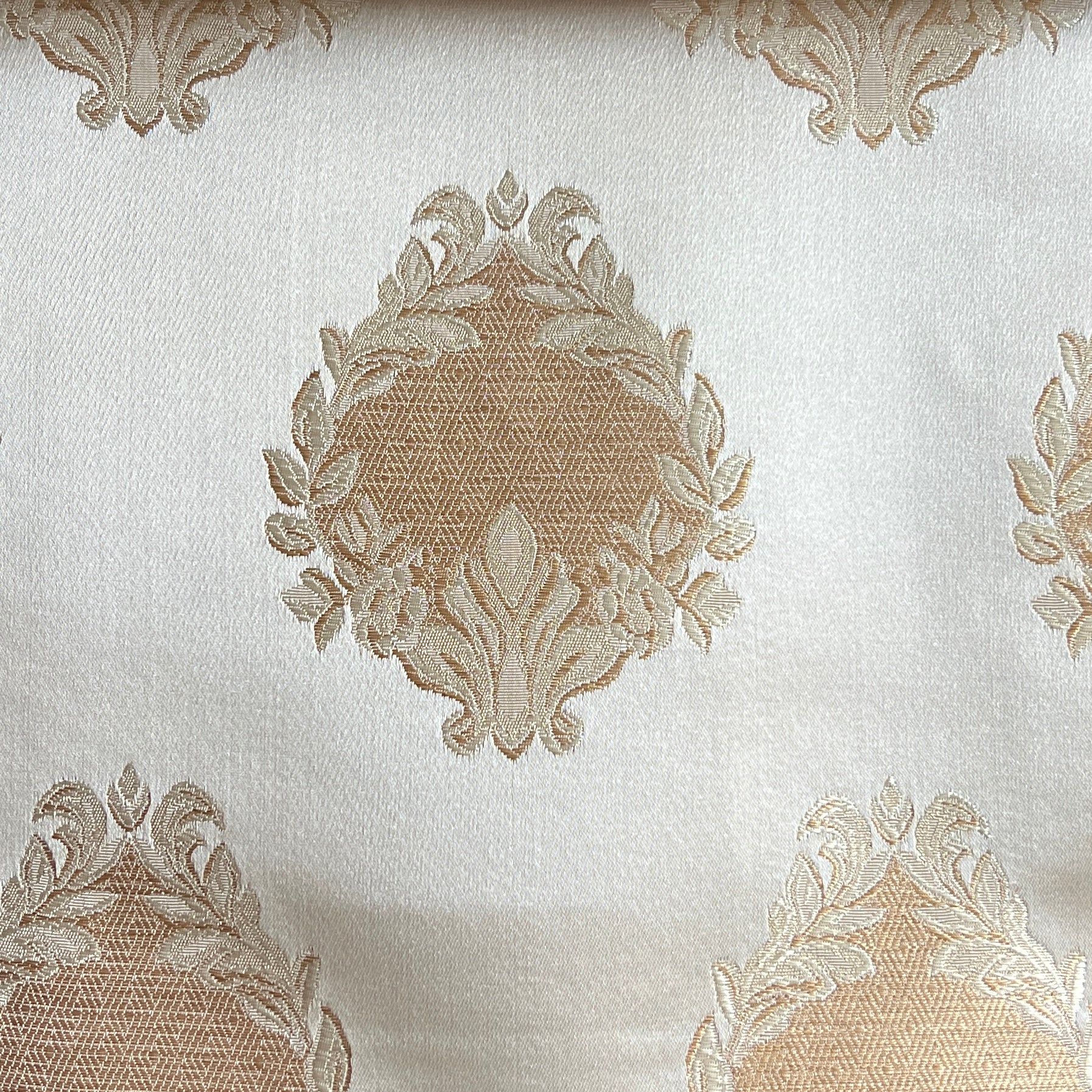 Decorative fabric with intricate floral gold patterns on a Cream background