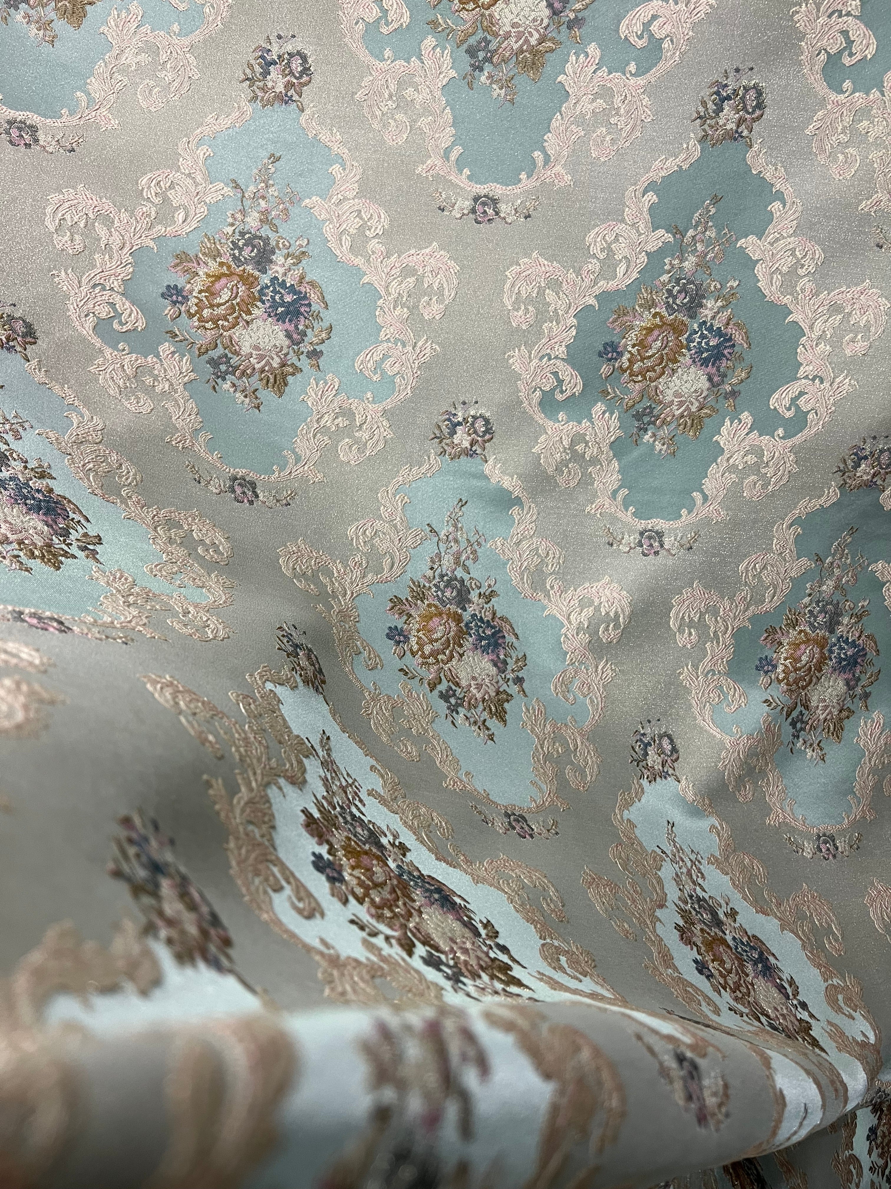 Decorative floral and leaf pattern on a Teal Blue background