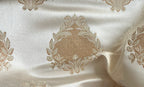 Decorative fabric with intricate floral gold patterns on a Cream background