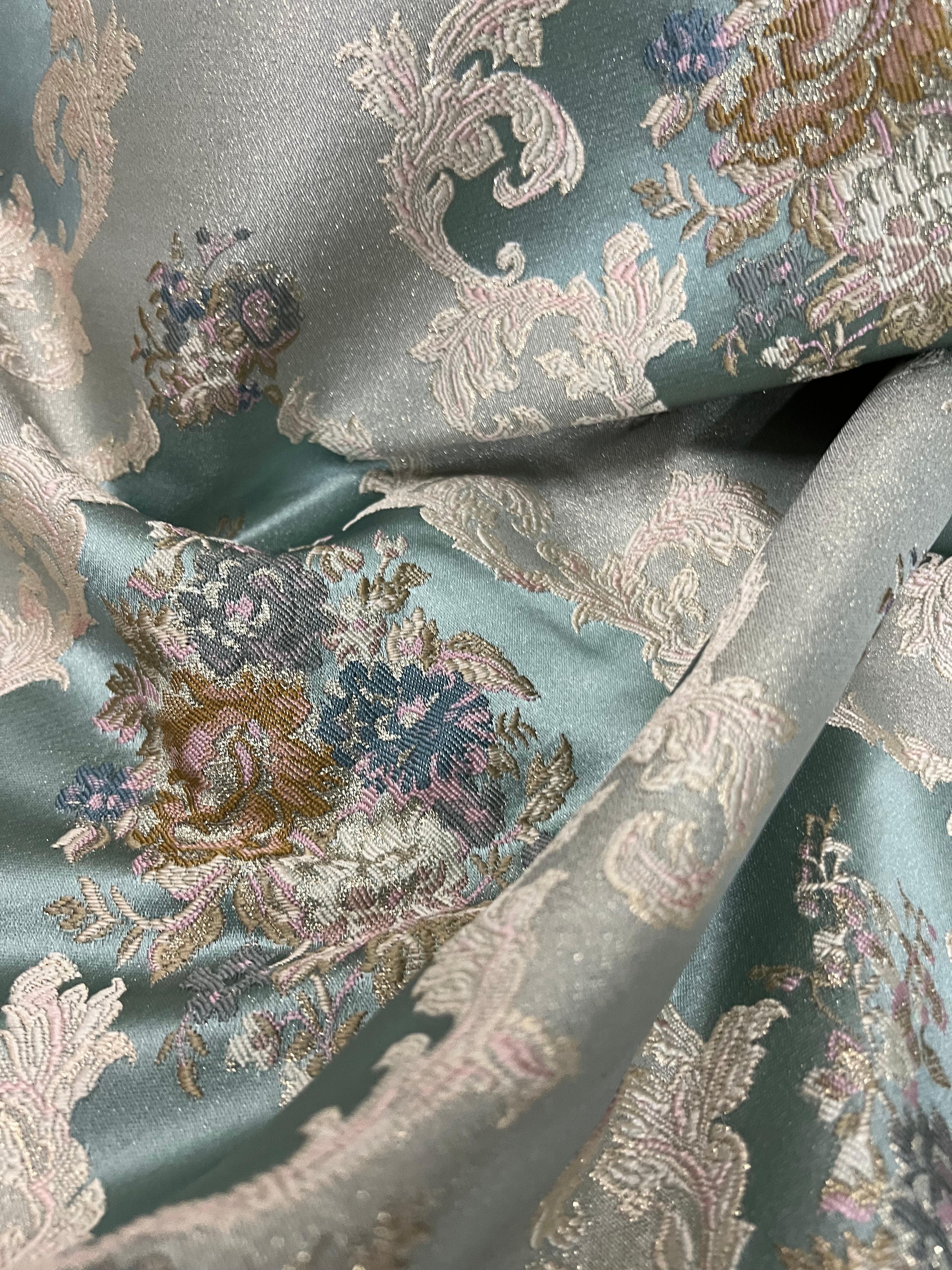 Decorative floral and leaf pattern on a Teal Blue background