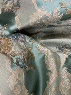 Decorative floral and leaf pattern on a Teal Blue background